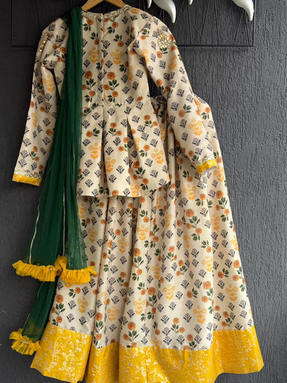 Marigold Printed peplum top With Lehenga And Net Dupatta
